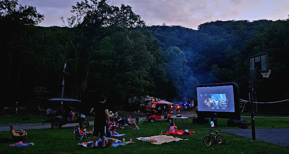 Campers gathering for an outdoor movie